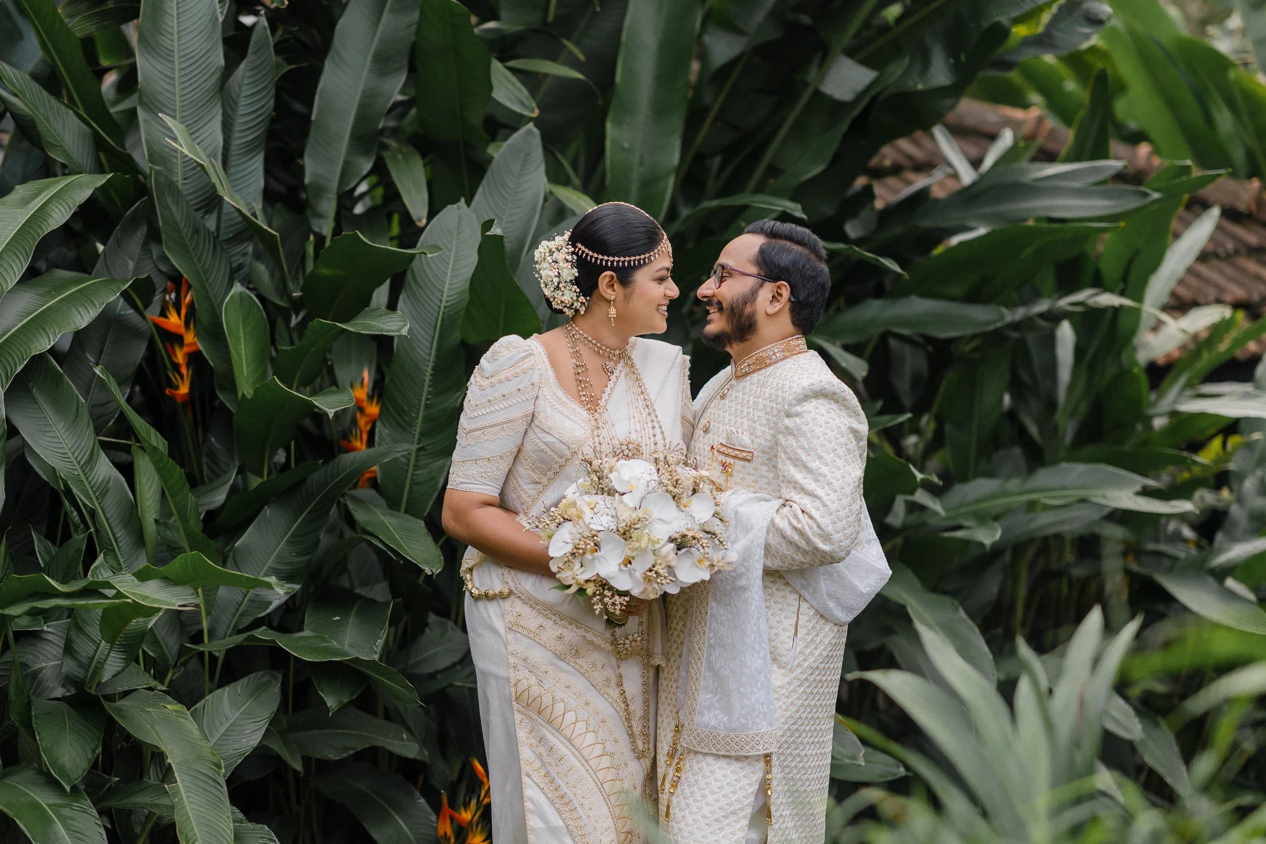 Bride and groom wearing coordinated ivory wedding attire